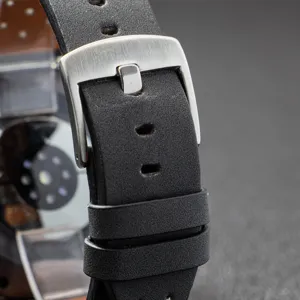 Black leather watch strap detail, breathable perforated design with brushed metal buckle.