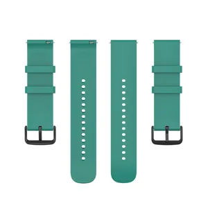 Detail view of smooth teal silicone watch strap with quick release pins and black buckle.