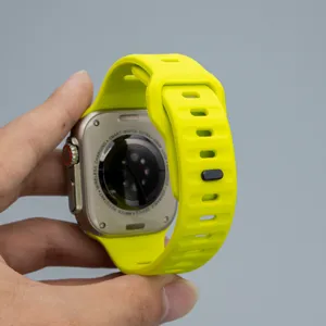 Bright yellow silicone watch band detail, breathable sports strap with secure snap button design.
