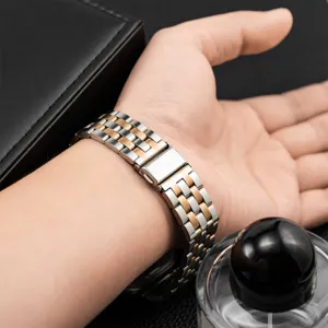 Detailed view of the stainless steel watch band with five-bead folding clasp worn