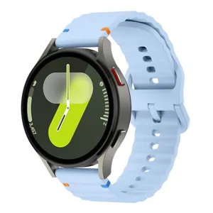 Light blue silicone watch strap with wave design and stitching, compatible with smartwatches.