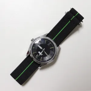 Nylon elastic watch strap detail view, adjustable black band with green center line, durable.