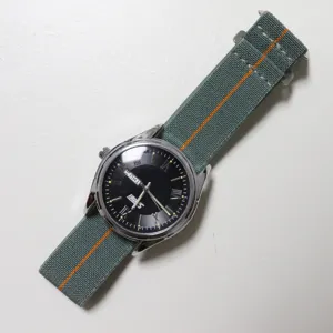 Detailed view of elastic nylon watch strap in grey and orange, parachute style replacement.