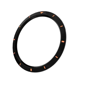 Gedetailleerde close-up van de zwarte horlogering met oranje markeringen voor accessoires.