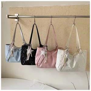 Detailed view of stylish star print shoulder tote bags with cute star charms and zipper pockets.