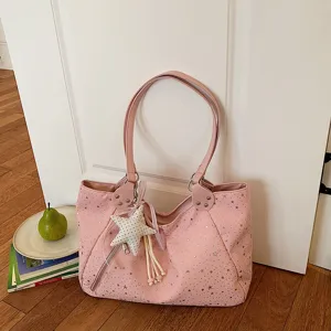 Close-up detail of the pink star pattern shoulder tote bag featuring a cute star pendant.