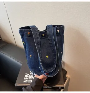 Sac cabas en jean chic avec broderie florale colorée, sac seau tendance pour femme cet été.