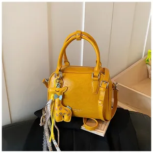 Yellow PU leather shoulder crossbody bag detail with cute giraffe pendant and lace charms.
