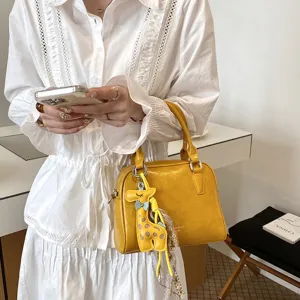 Yellow shoulder crossbody small square bag detail, casual commute versatile chic daily styling.