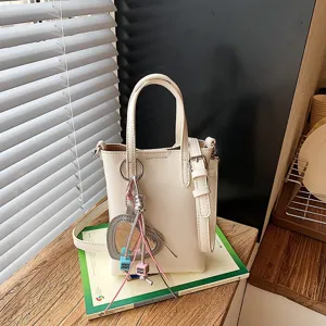 Mini beige cross body phone bag for women, chic PU leather shoulder bag for commute daily.