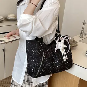 Black star print shoulder tote bag with side zipper and cute white star ribbon pendant detail.