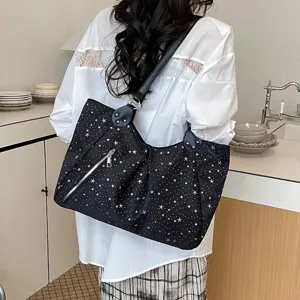 Black star print shoulder tote bag with front zipper pocket for daily commute use.