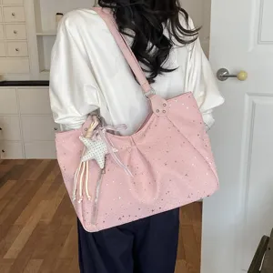 Pink shoulder underarm tote bag detail view featuring cute star pattern and charm.