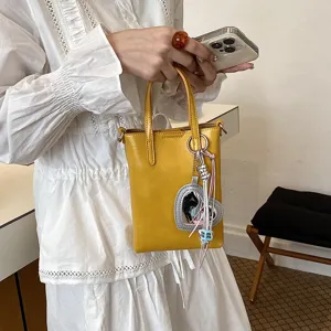 Yellow PU leather mini crossbody phone bag with heart mirror pendant and cute charm beads style.