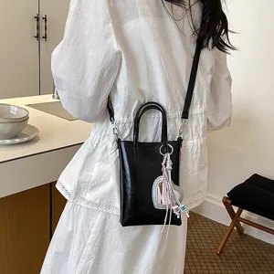 Stylish black PU leather cross-body phone bag for women, chic commuting daily shoulder purse.