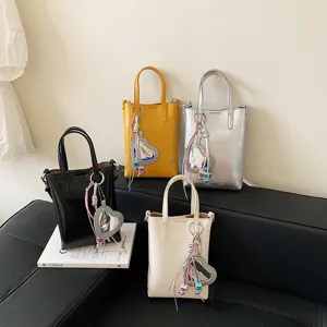 Trendy minimalist small tote phone bag with heart pendant, multi-color shoulder crossbody bag.