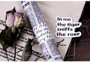 Vintage decorative paper stickers detail view featuring artistic English quote designs.