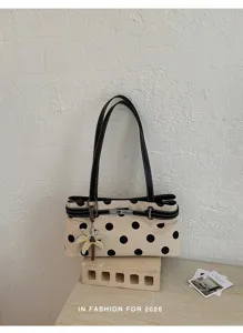 Sac épaule chic à pois avec fermoir tournant en métal et charm palmier très stylé.