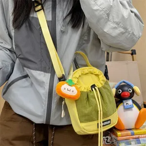 Casual contrast color nylon bucket crossbody bag detailed shot featuring cute pumpkin charm.