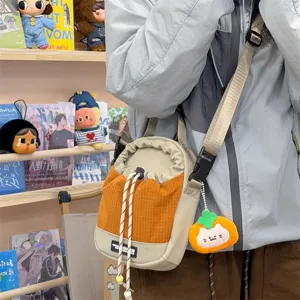 Casual fashion crossbody bag, stylish canvas shoulder bag with drawstring and cute pendant.