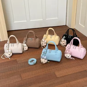 Close-up detail shot of multi-color fashion commuter crossbody pillow bags with charms