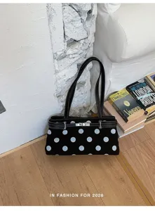 Chic sac porté épaule noir à pois pour femme, élégant sac sous les bras avec serrure métal.