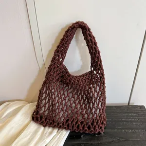 Brown woven mesh shoulder bag detail view, casual knitted hobo bag texture shot.