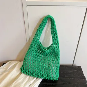 Green crochet net shoulder bag detail, stylish hollow out knit hobo handbag for women.