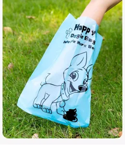 Disposable pet dog poop bag detail shot, light blue plastic waste bag with cute cartoon dog.