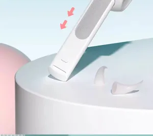 Detail shot of pet nail clipper part, white plastic design, clean aesthetic close up view.
