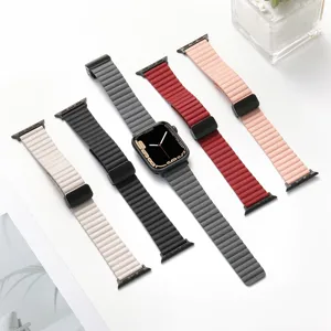 Detailed view of magnetic leather watch straps in various colors on white surface.