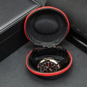 Portable round watch storage box with red zipper closure and soft interior lining protection.