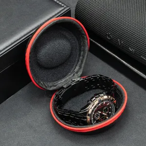 Portable round watch travel storage case with red zipper and soft lining for watches.