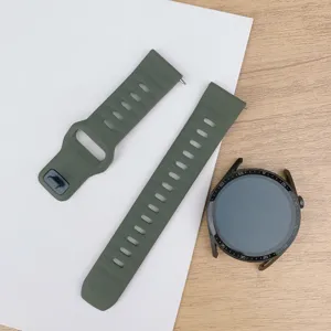 Detailed view of military green silicone watch strap, universal replacement band with black buckle.