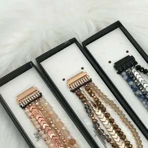 Multi-strand beaded watch band detail showing crystal beads and quick-release connectors.