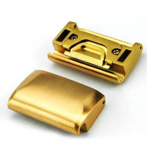 Close-up view of gold metal watch strap quick release link connectors, detailed metal texture.