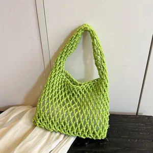 Bright green woven net underarm bag detail, stylish hollow mesh shoulder bag design.