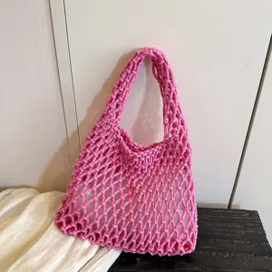 Pink knit woven mesh shoulder bag detail view, stylish casual underarm handbag texture.