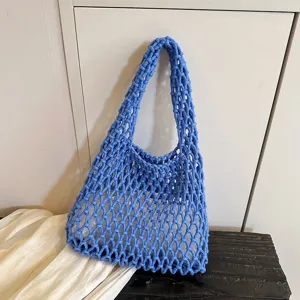 Blue woven crochet shoulder bag detail, casual hollow net hobo tote design for daily fashion look.