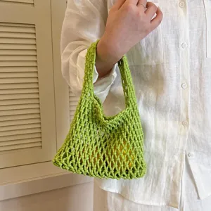 Green woven mesh handbag detail shot, stylish hollow out design for daily chic look.