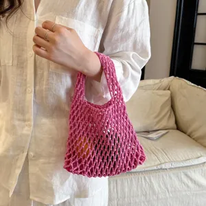 Pink woven mesh handbag detail, stylish casual crochet tote bag for daily wear.