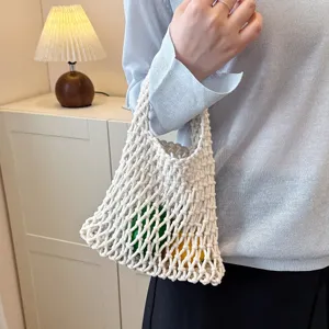 Detailed shot of a beige woven macrame net bag showcasing its intricate textured mesh design.