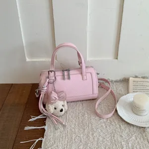 Pink leather pillow shoulder crossbody bag with cute puppy charm, stylish niche design.