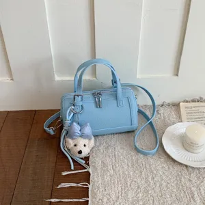 Chic light blue shoulder crossbody pillow bag with cute puppy plush pendant for women stylish.