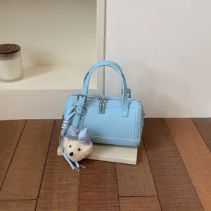 Light blue PU leather pillow bag with cute bow bear pendant, stylish crossbody handbag.