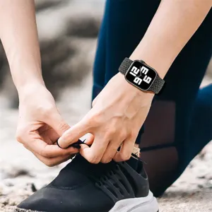 Detailed shot of the woven nylon watch strap worn on wrist during outdoor activity.