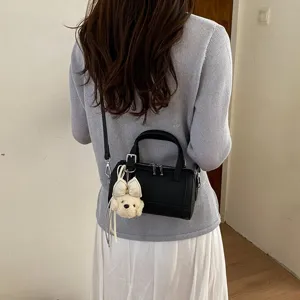 Chic mini crossbody pillow bag with cute plush pendant, stylish commuter shoulder bag.