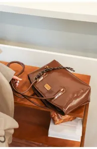 Brown PU leather shoulder tote bag, casual daily commute commuter bag with woven strap detail.