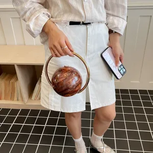 Stylish round hard shell handbag with metal ring handle, unique marble pattern evening clutch bag.