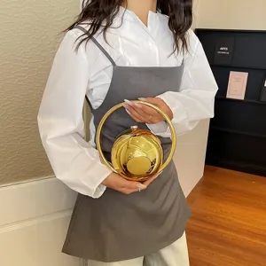 Gold metal sphere handbag with ring handle, chic niche design for evening parties and commute.